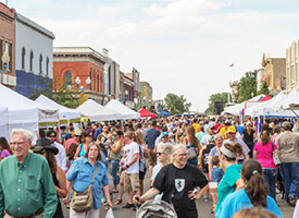 Image of crowded downtown Laramie as people visit the Farmer's Market.